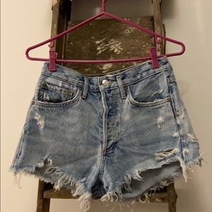 Agolde light denim ripped jean shorts.